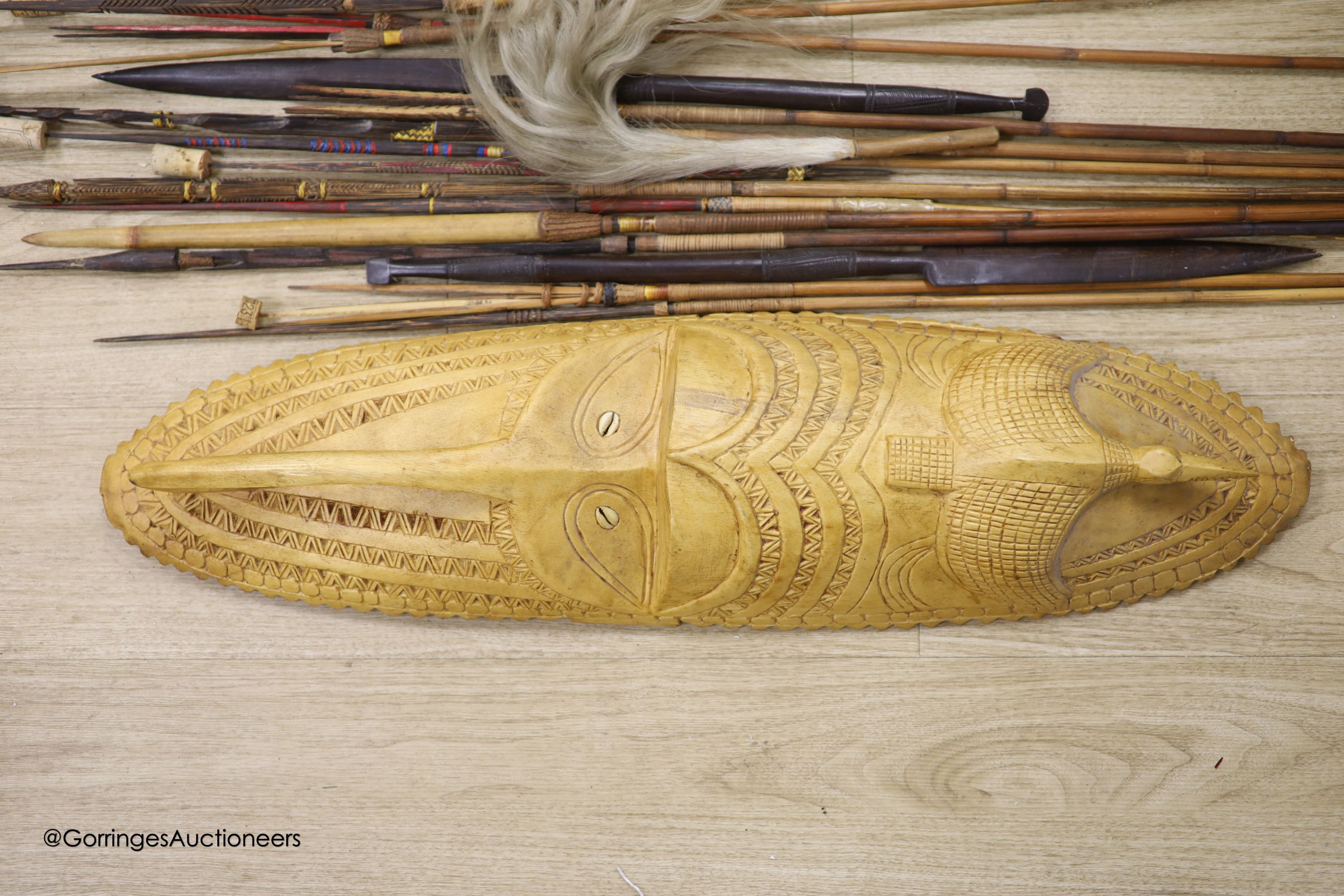 A collection of Tribal style spears etc and a mask